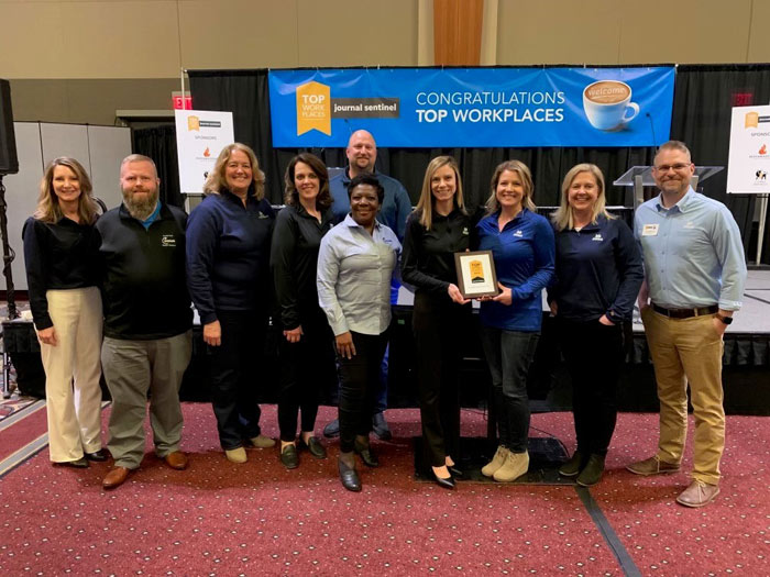 Group of people accepting a top workplace award