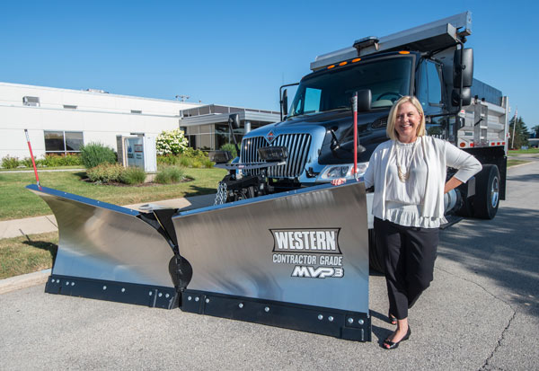 Sarah Lauber next to a Western plow