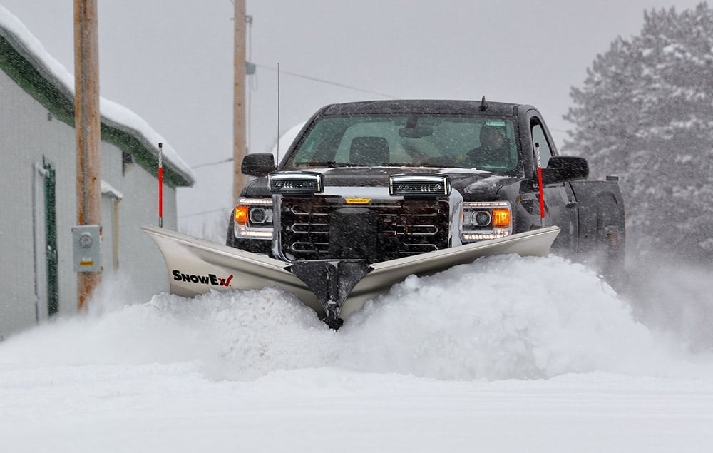 Truck pushing snow with a SnowEx plow