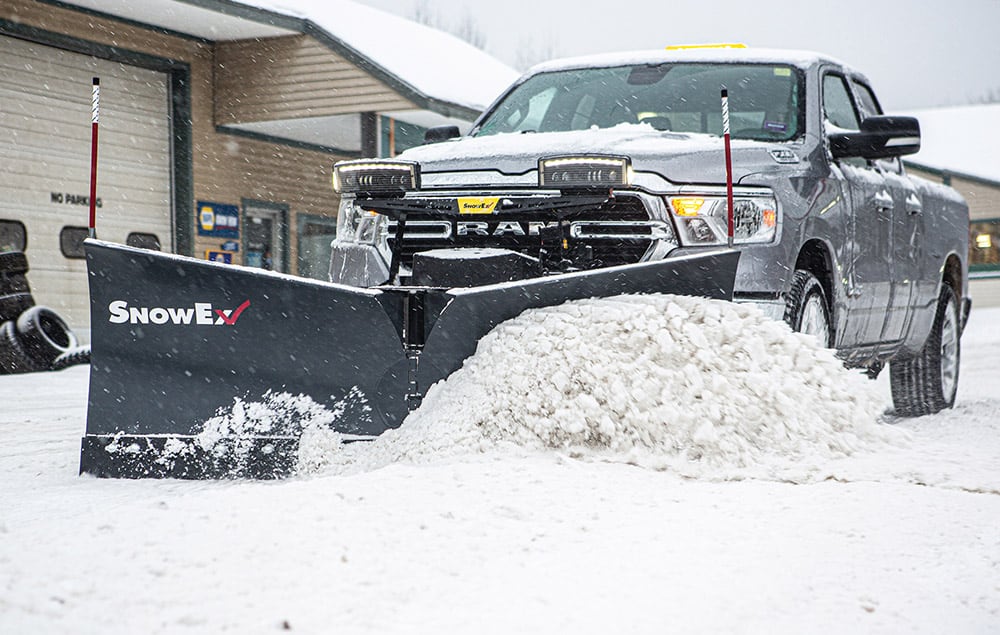 Truck pushing snow with a SnowEx plow