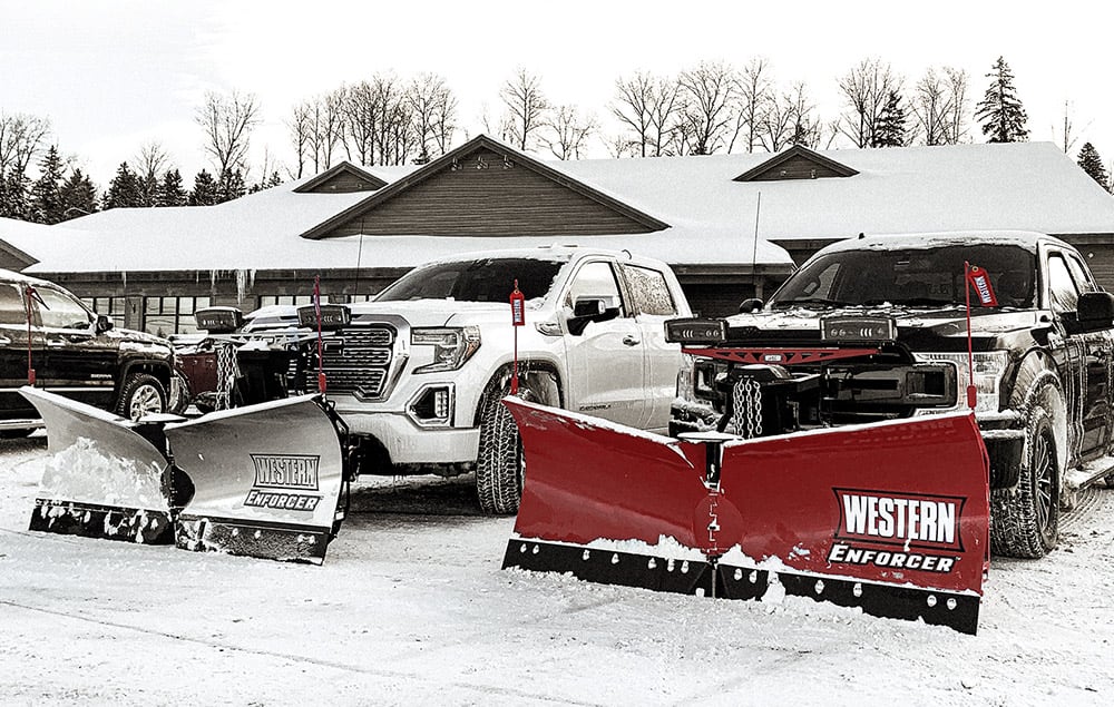 Two trucks with Western plows