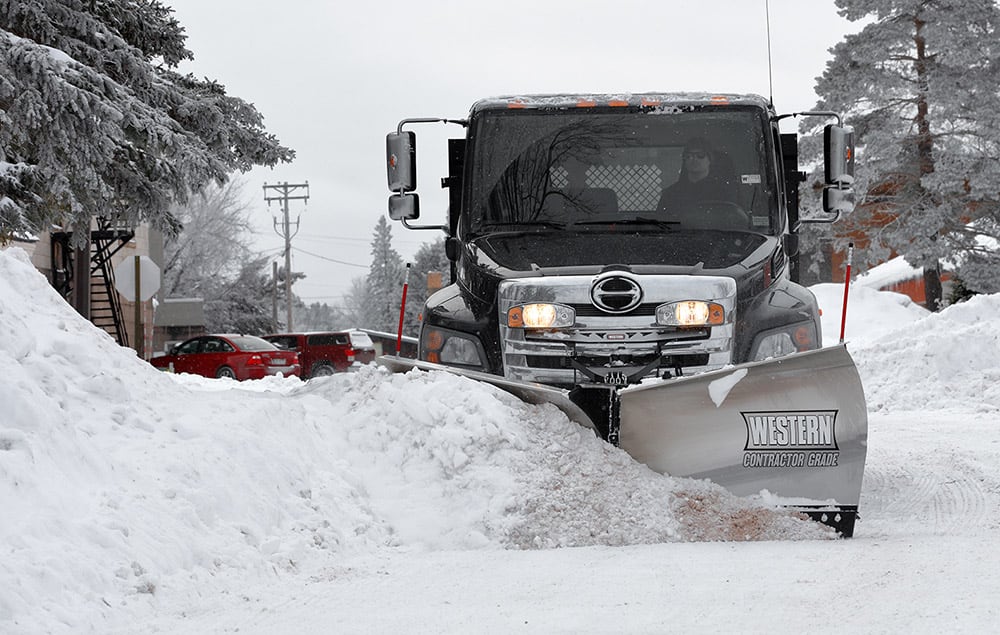 Truck pushing snow with Western plow