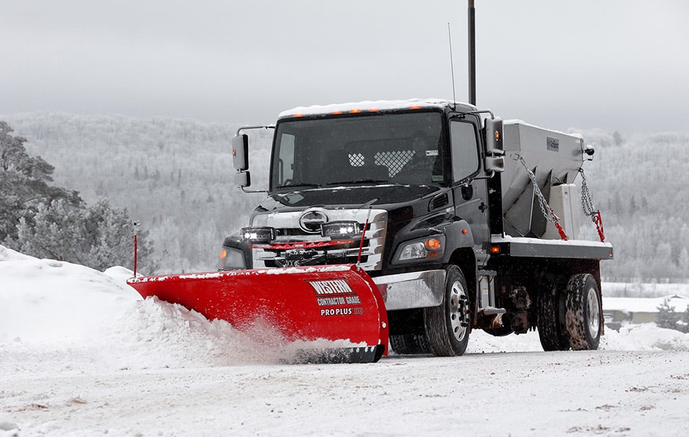 Truck pushing snow with Western plow