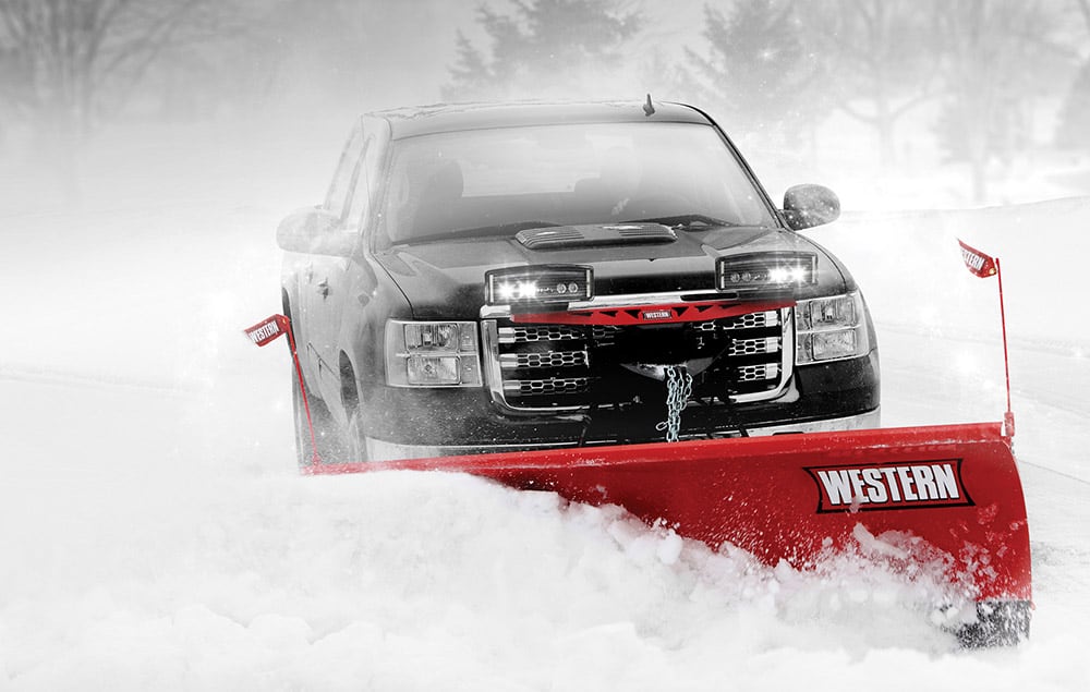 Truck pushing snow with Western plow