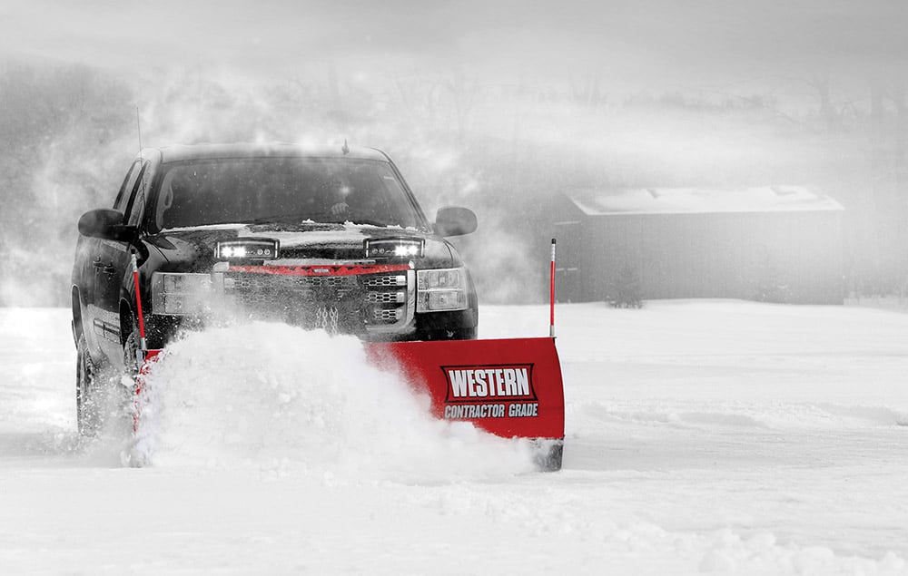 Truck pushing snow with Western plow