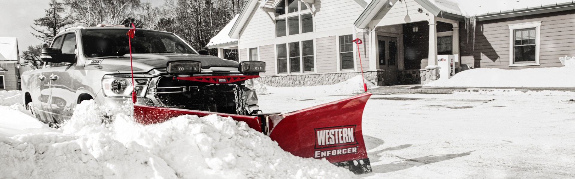 A truck pushing snow with a Western plow