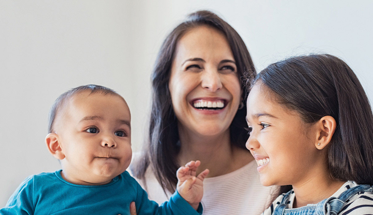 Family with mom, young daughter, and baby