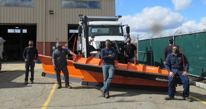 People in front of a Henderson plow