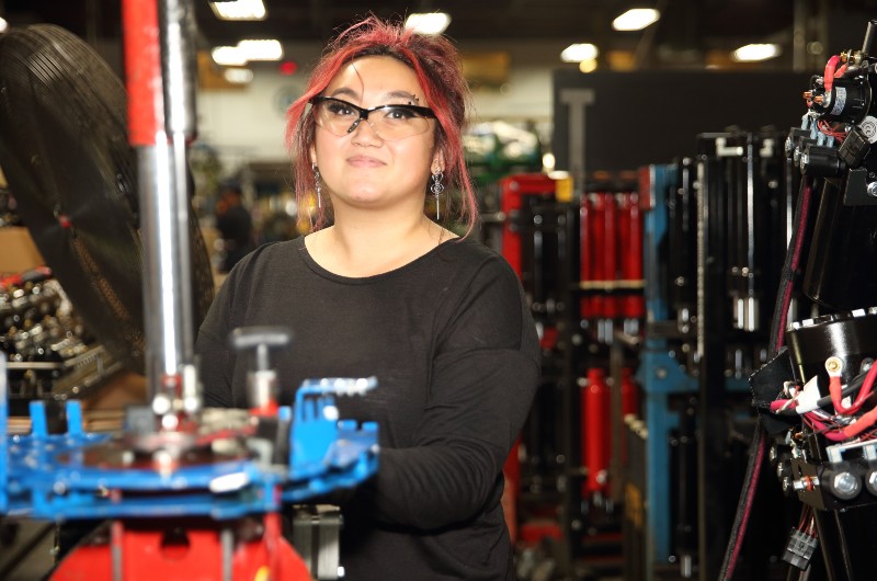 Woman working with manufacturing equipment