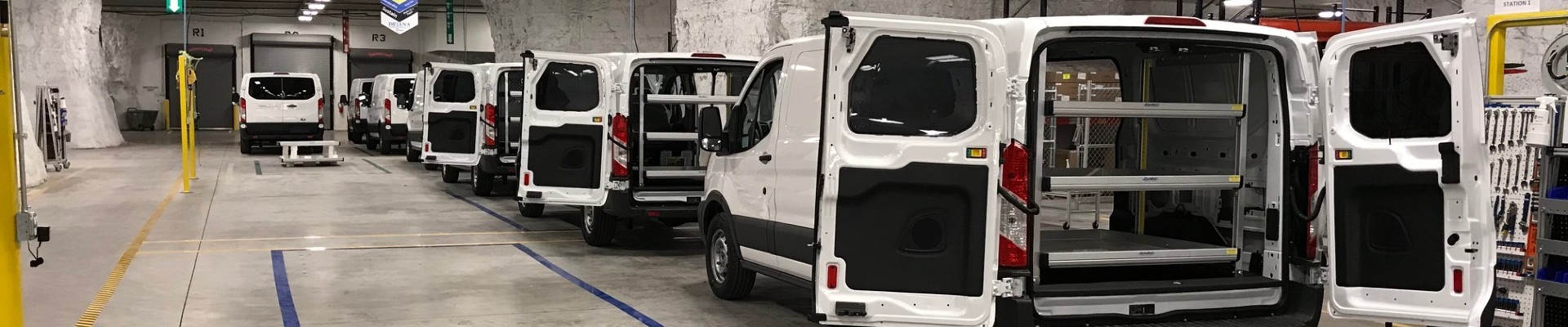 Group of vans with their rear doors open