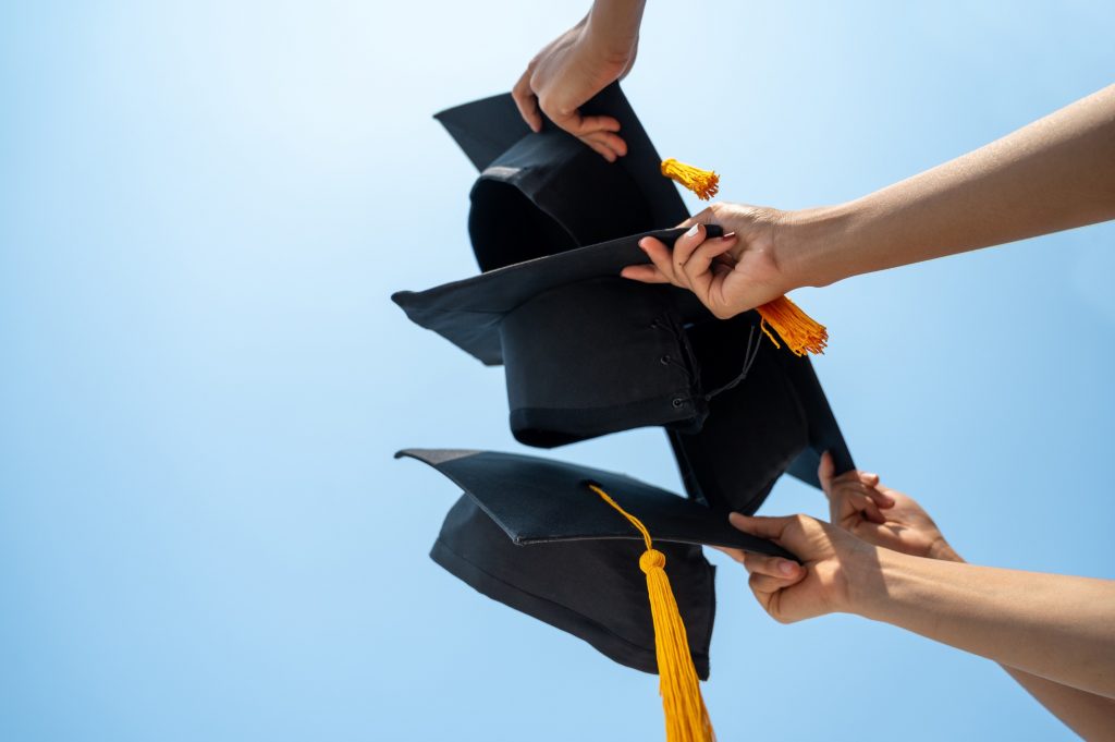 People holding graduation caps