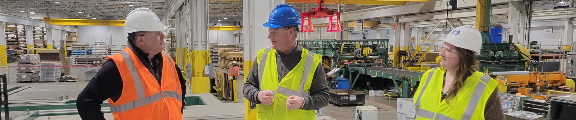 Three workers in a warehouse