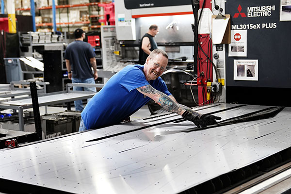 Man working with raw materials and a machine